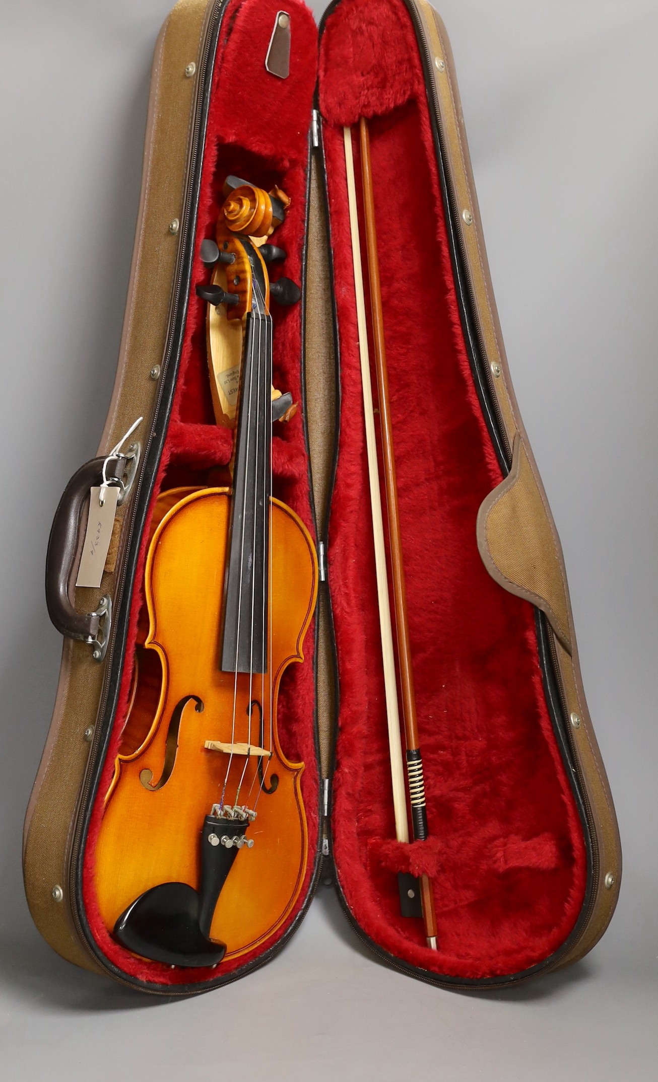 A cased child's violin and bow with ivorine tip, violin 55cms long